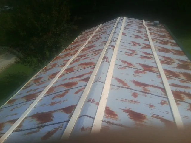 Rusted metal roof panels with new wood purlins before replacement — Storm Damage Roof Repair in Lower Salem by Roofing Brothers