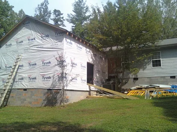 Tyvek wrapped gable on a new room addition beside an existing home in Lower Salem
