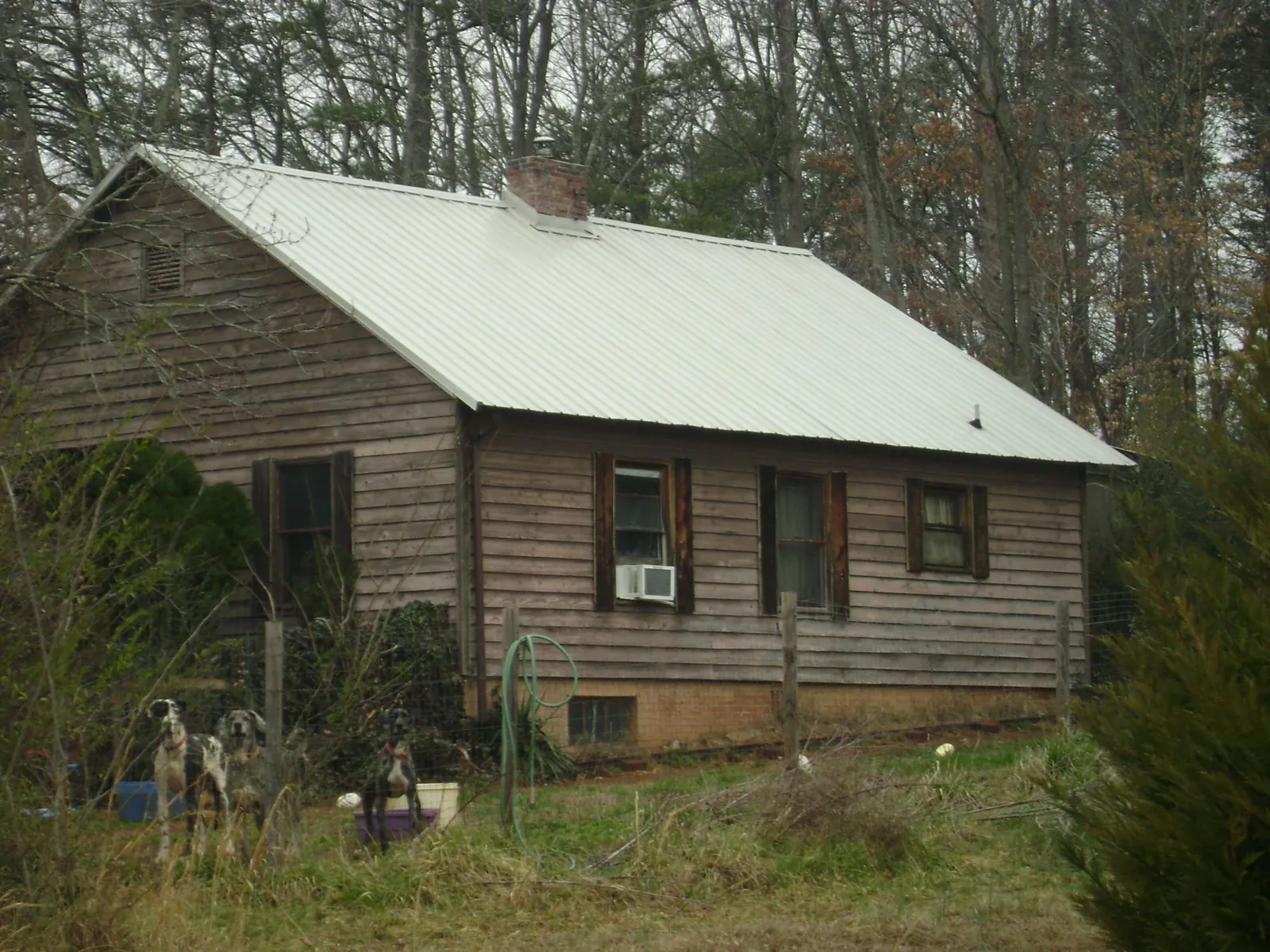 White metal roof on an old wood sided farmhouse, from a Metal Roof Installation job in Lower Salem